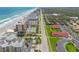 Beautiful aerial view of coastal condos near sandy beaches, with pristine tennis courts, providing a luxurious lifestyle at 4139 S Atlantic Ave # B707, New Smyrna Beach, FL 32169