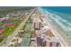 Stunning aerial view of oceanfront condos and private tennis courts along the beach, with ocean views at 4139 S Atlantic Ave # B707, New Smyrna Beach, FL 32169