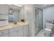Bathroom featuring a vanity, mirror, and a shower with glass doors, designed for comfort at 4139 S Atlantic Ave # B707, New Smyrna Beach, FL 32169