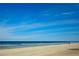 Beautiful beach with tranquil water and blue sky at 4139 S Atlantic Ave # B707, New Smyrna Beach, FL 32169