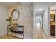 Tastefully decorated condo entryway with modern console table and view down bright hallway at 4139 S Atlantic Ave # B707, New Smyrna Beach, FL 32169