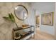 Stylish entryway featuring modern decor, a decorative mirror and adjacent bathroom at 4139 S Atlantic Ave # B707, New Smyrna Beach, FL 32169