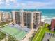 Coastal condo building features a tennis court, parking, and balconies overlooking the ocean at 4139 S Atlantic Ave # B707, New Smyrna Beach, FL 32169