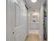 Hallway leading to a bathroom with a vanity, mirror, and shower, with closet in the hallway at 4139 S Atlantic Ave # B707, New Smyrna Beach, FL 32169