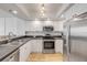Bright kitchen features stainless steel appliances and white cabinets at 4139 S Atlantic Ave # B707, New Smyrna Beach, FL 32169