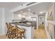 Bright kitchen features stainless steel appliances and white cabinets that opens to the breakfast bar at 4139 S Atlantic Ave # B707, New Smyrna Beach, FL 32169