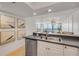 Bright kitchen features stainless steel appliances and white cabinets that opens to the living area at 4139 S Atlantic Ave # B707, New Smyrna Beach, FL 32169