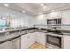 Bright kitchen features stainless steel appliances and white cabinets at 4139 S Atlantic Ave # B707, New Smyrna Beach, FL 32169