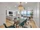 Spacious living area with a dining area, a modern chandelier, and floor-to-ceiling windows with ocean views at 4139 S Atlantic Ave # B707, New Smyrna Beach, FL 32169