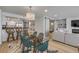 Open-concept living space showcasing dining area, kitchen, and living room with barn doors at 4139 S Atlantic Ave # B707, New Smyrna Beach, FL 32169