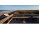 Wooden observation deck offering picturesque views of the beach and coastal landscape at 4139 S Atlantic Ave # B707, New Smyrna Beach, FL 32169