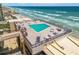 Stunning rooftop pool with ocean views, surrounded by lounge chairs and tables for relaxation at 4139 S Atlantic Ave # B707, New Smyrna Beach, FL 32169