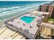 Relaxing rooftop pool with ample seating, offering stunning ocean views for residents to enjoy at 4139 S Atlantic Ave # B707, New Smyrna Beach, FL 32169