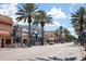 Charming street view lined with palm trees, shops, and vibrant storefronts at 4139 S Atlantic Ave # B707, New Smyrna Beach, FL 32169