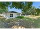The backyard offers ample space with a mix of lawn, landscaping, and a view of the home's exterior at 4306 Pebblestone Ct, Orlando, FL 32826