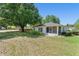 Back exterior view of house, showcasing the screened porch and ample green space at 4306 Pebblestone Ct, Orlando, FL 32826