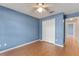 This bedroom features a ceiling fan, a double door closet, and laminate flooring at 4306 Pebblestone Ct, Orlando, FL 32826