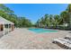 Large community pool with surrounding lounge area and lush tropical landscaping at 4306 Pebblestone Ct, Orlando, FL 32826