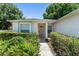 Inviting front entrance with well-maintained landscaping surrounding the walkway to the front door at 4306 Pebblestone Ct, Orlando, FL 32826