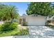 Charming single-story home with a well-manicured lawn, mature landscaping, and a two-car garage at 4306 Pebblestone Ct, Orlando, FL 32826
