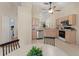 Bright kitchen with light-toned cabinets, neutral walls, and open layout to a breakfast area and bedroom at 4306 Pebblestone Ct, Orlando, FL 32826