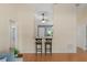 Sunlit living space with modern bar seating, hardwood floors, and a view to the den at 4306 Pebblestone Ct, Orlando, FL 32826