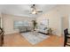 Bright living room with large windows, hardwood floors, and modern furnishings at 4306 Pebblestone Ct, Orlando, FL 32826