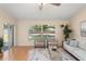 Sunlit living room with sliding glass doors to the lanai, hardwood floors and comfortable seating at 4306 Pebblestone Ct, Orlando, FL 32826