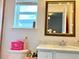 Compact bathroom featuring a vanity with a mirror and a window for natural light at 5637 Beggs Road, St Cloud, FL 34771