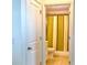 Bathroom with tiled floors, toilet, and shower with yellow and gray stripped shower curtain at 5637 Beggs Road, St Cloud, FL 34771