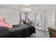 Small bedroom with bed, desk, and a window, with an attached bathroom at 5637 Beggs Road, St Cloud, FL 34771