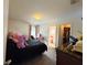 A simple bedroom with a black bed and an open bathroom in the background at 5637 Beggs Road, St Cloud, FL 34771