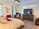 Cozy bedroom featuring a comfortable bed, a TV, and a dedicated workspace at 5637 Beggs Road, St Cloud, FL 34771