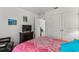 Comfortable bedroom with matching furniture with an attached closet and tv at 5637 Beggs Road, St Cloud, FL 34771