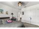 A bedroom with cartoon art, neutral-colored walls, and carpeted floors offers a cozy, personalized space at 5637 Beggs Road, St Cloud, FL 34771