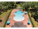Aerial view of community pool surrounded by lounge chairs and lush landscaping offers a resort-style living experience at 5637 Beggs Road, St Cloud, FL 34771