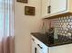 Stylish countertop complements the classic white cabinetry and modern backsplash at 5637 Beggs Road, St Cloud, FL 34771