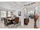 Stylish dining room open to the kitchen, with a large table, chic decor, and natural light at 5637 Beggs Road, St Cloud, FL 34771