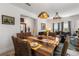 Elegant dining area featuring a rustic wood table, woven chairs, and stylish pendant lighting at 5637 Beggs Road, St Cloud, FL 34771