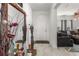 Bright foyer featuring tile flooring, a decorative mirror, and an open view to the living room at 5637 Beggs Road, St Cloud, FL 34771