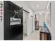 Hallway with decorative barn door, leading to the entrance and other rooms at 5637 Beggs Road, St Cloud, FL 34771