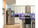 Modern kitchen equipped with stainless steel appliances and stylish backsplash at 5637 Beggs Road, St Cloud, FL 34771