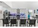 Modern kitchen featuring a large island with seating, stylish backsplash, and stainless steel appliances at 5637 Beggs Road, St Cloud, FL 34771
