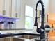 Close-up of a modern kitchen sink with a stylish black faucet and stainless steel basin at 5637 Beggs Road, St Cloud, FL 34771