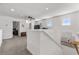 Upstairs landing area with neutral carpet, natural lighting, and a ceiling fan at 5637 Beggs Road, St Cloud, FL 34771
