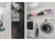 Laundry room with front-loading washer and dryer, and barn door at 5637 Beggs Road, St Cloud, FL 34771