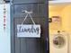 Charming laundry room featuring a sliding barn door and a modern washing machine at 5637 Beggs Road, St Cloud, FL 34771