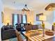 Inviting living room features elegant decor, a modern chandelier, and comfortable seating at 5637 Beggs Road, St Cloud, FL 34771