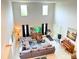 Open-concept living room with high ceilings, large windows, and stylish furnishings at 5637 Beggs Road, St Cloud, FL 34771