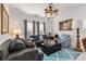 Inviting living room with comfortable seating, a decorative chandelier, and ample natural light at 5637 Beggs Road, St Cloud, FL 34771